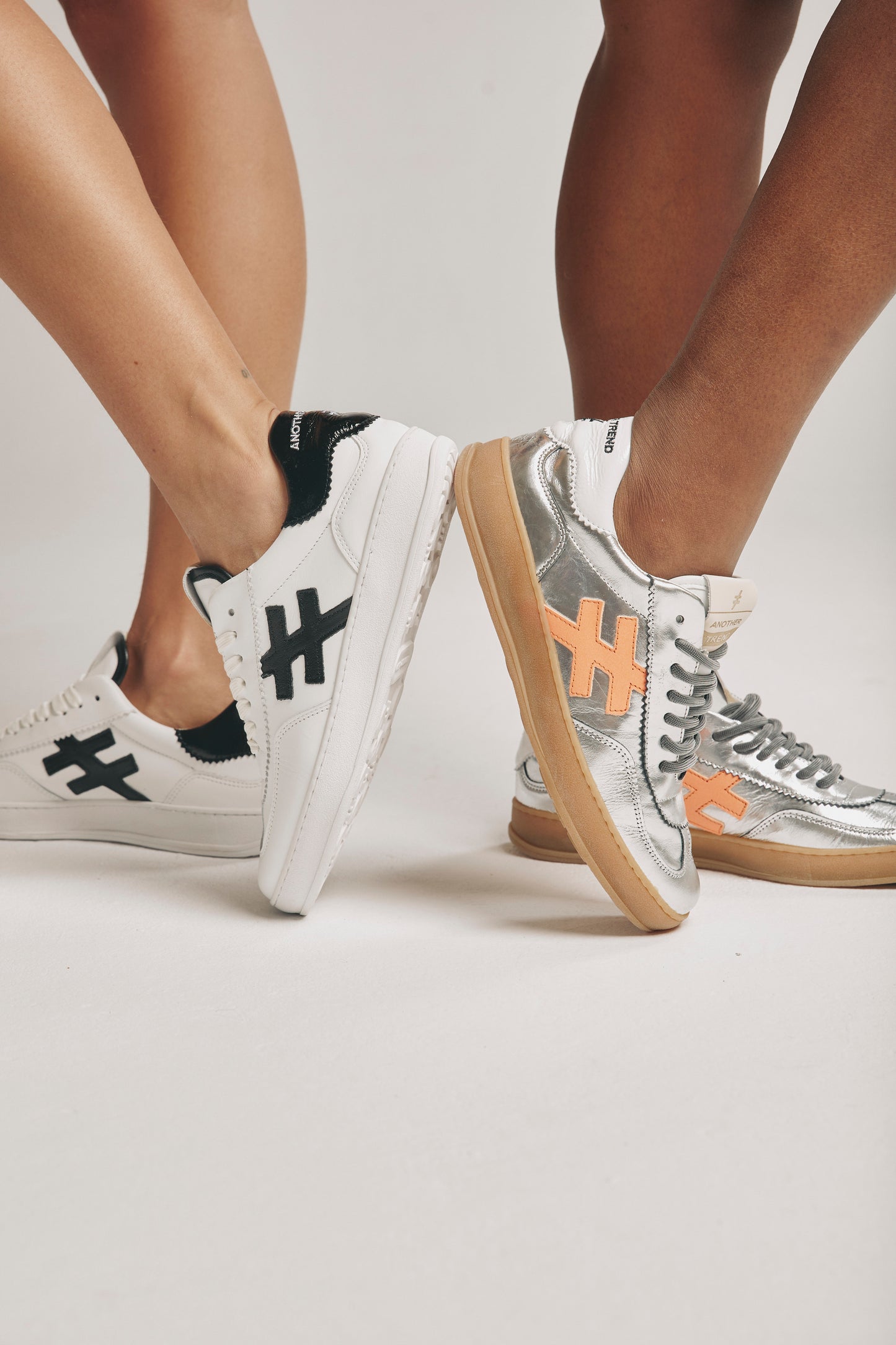 Another Trend A0325841 Metallic Trainers with White Back & Orange Logo