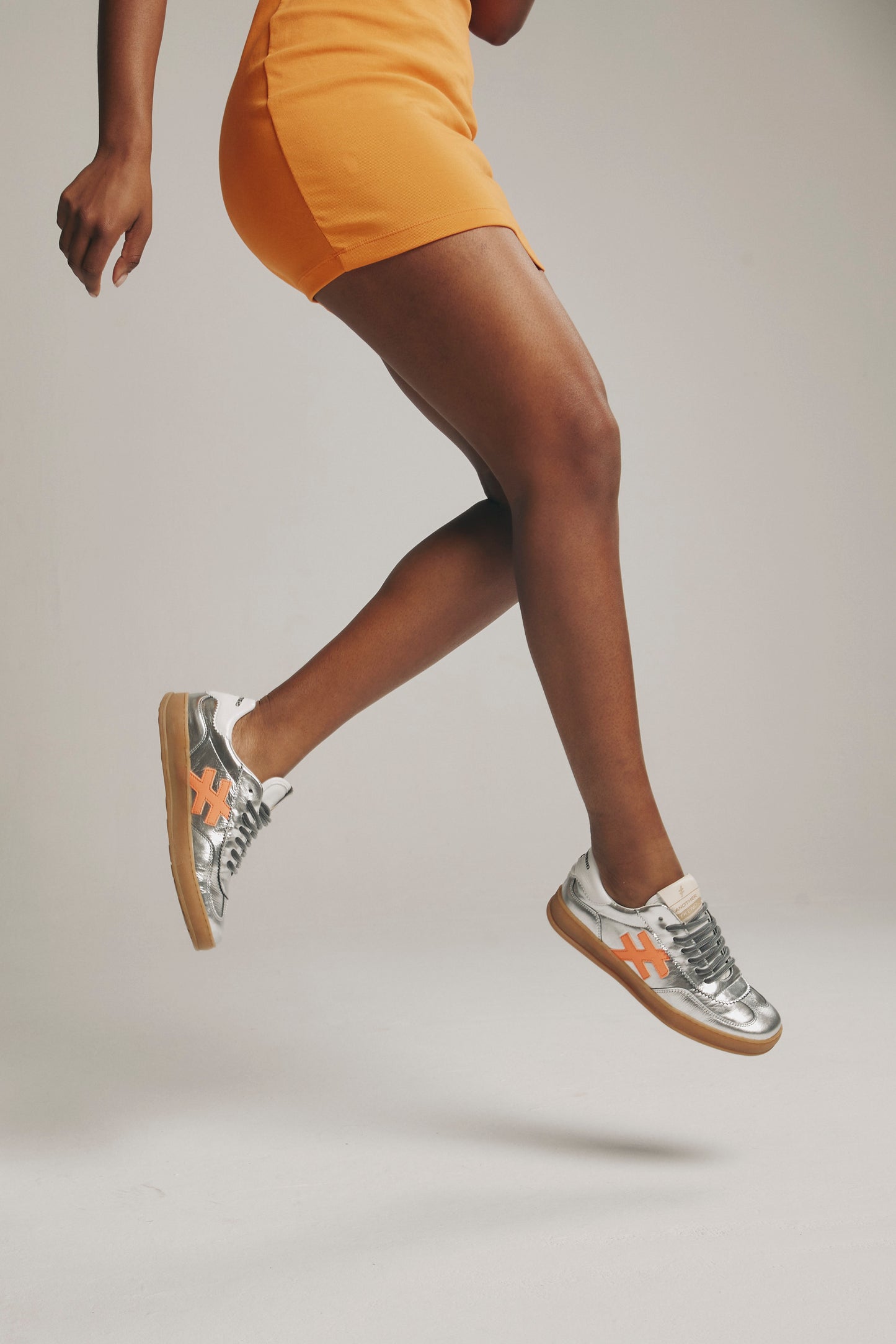 Another Trend A0325841 Metallic Trainers with White Back & Orange Logo